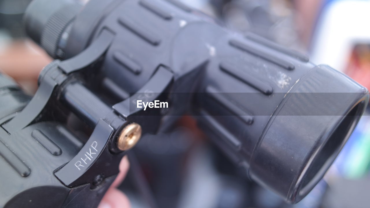 CLOSE-UP OF HUMAN HAND HOLDING CAMERA AT HOME