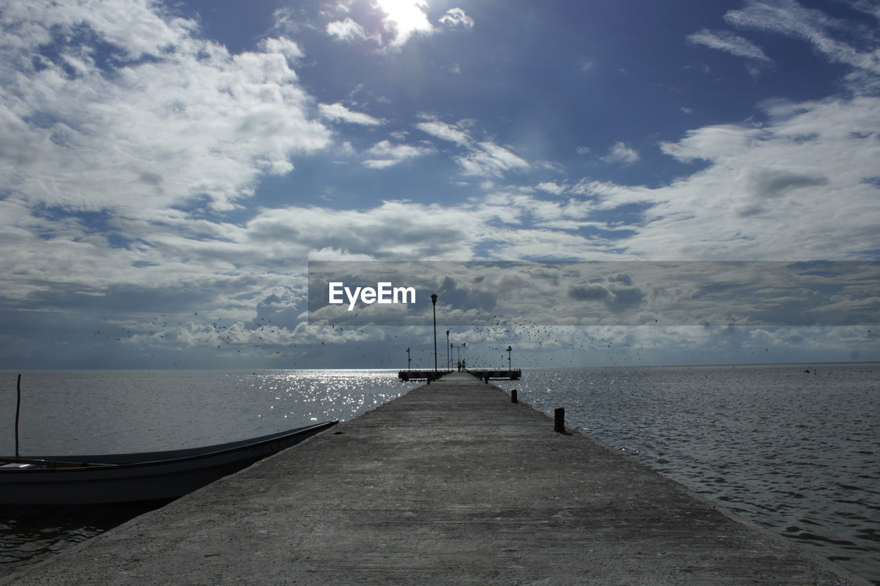 Pier over sea against sky