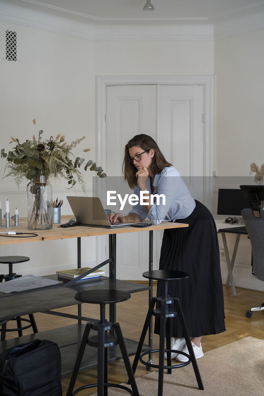 Woman using laptop at home