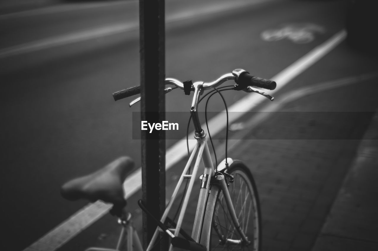 Close-up of bicycle on footpath