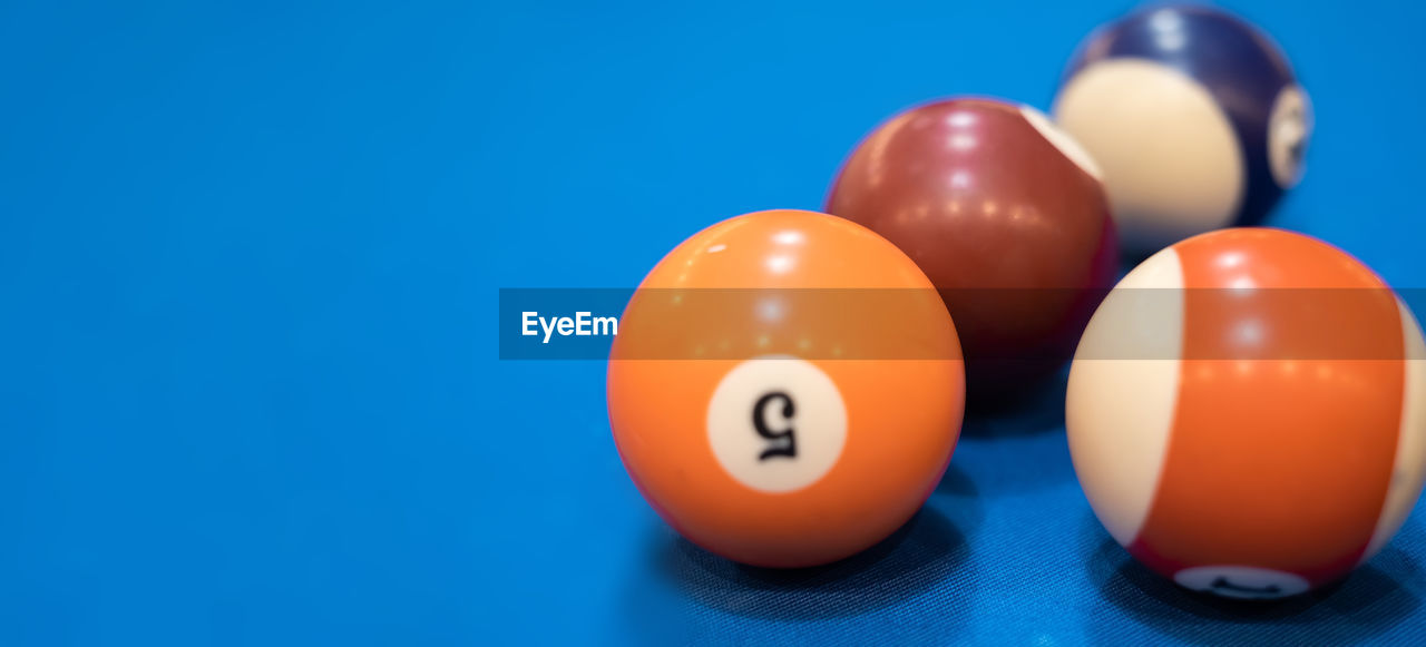 Close-up of pool balls on blue background