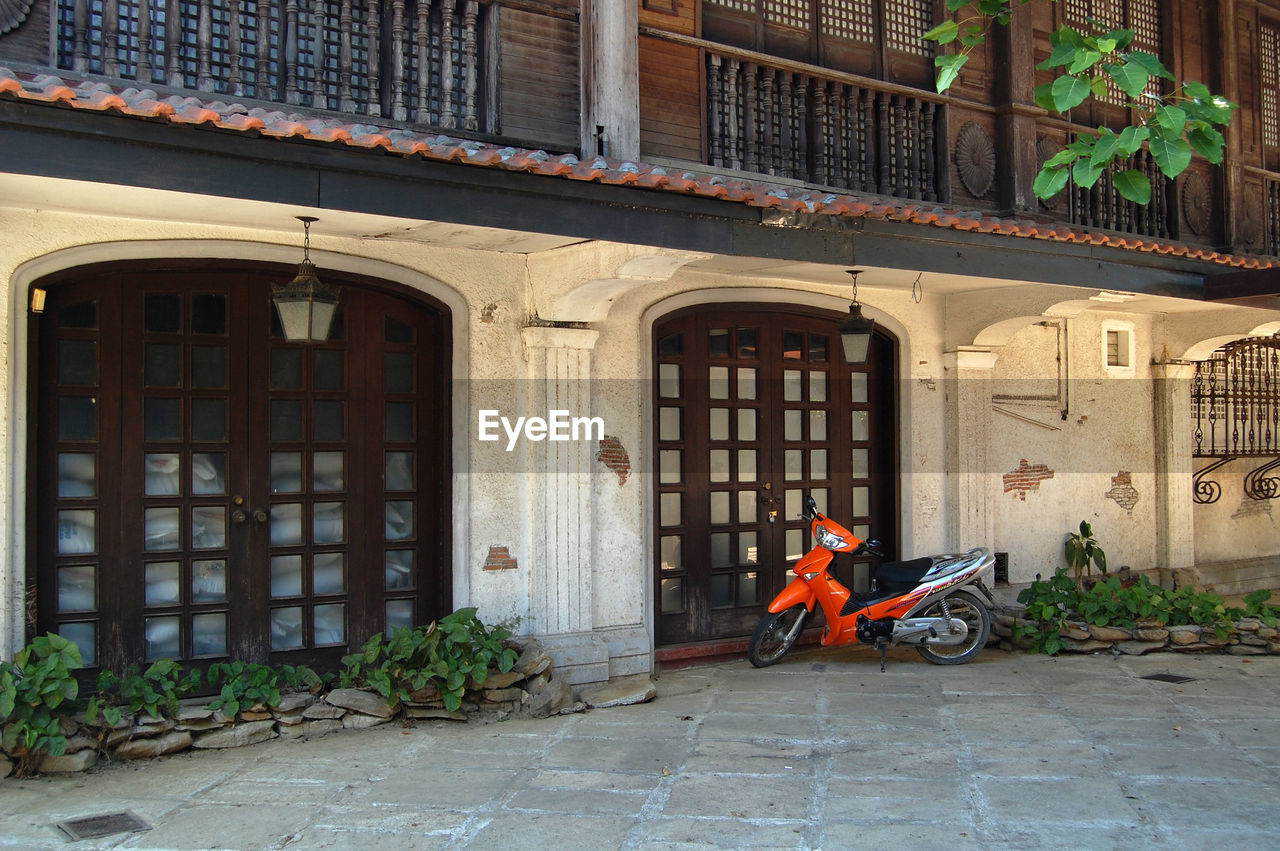 MAN OUTSIDE HOUSE ON BUILDING