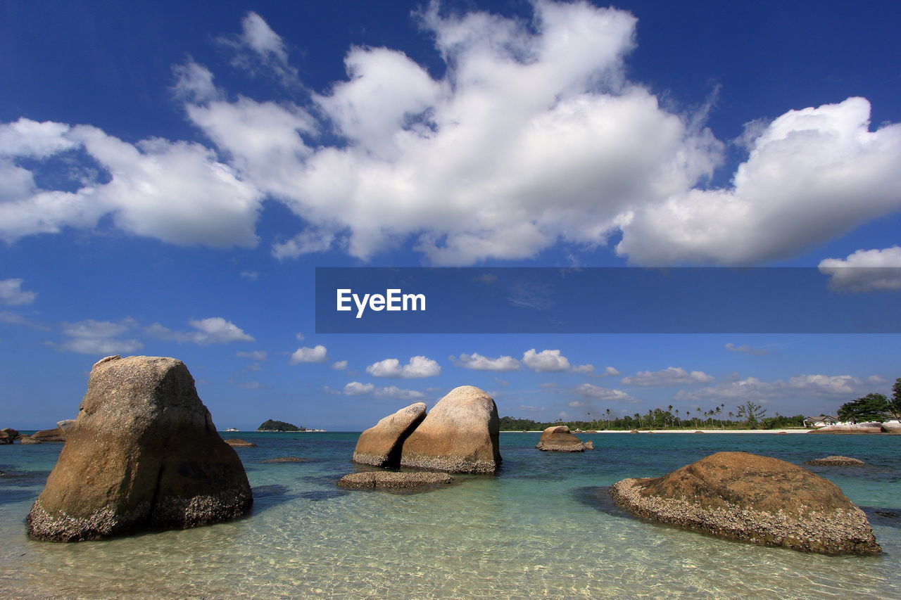 Rocks in sea against sky