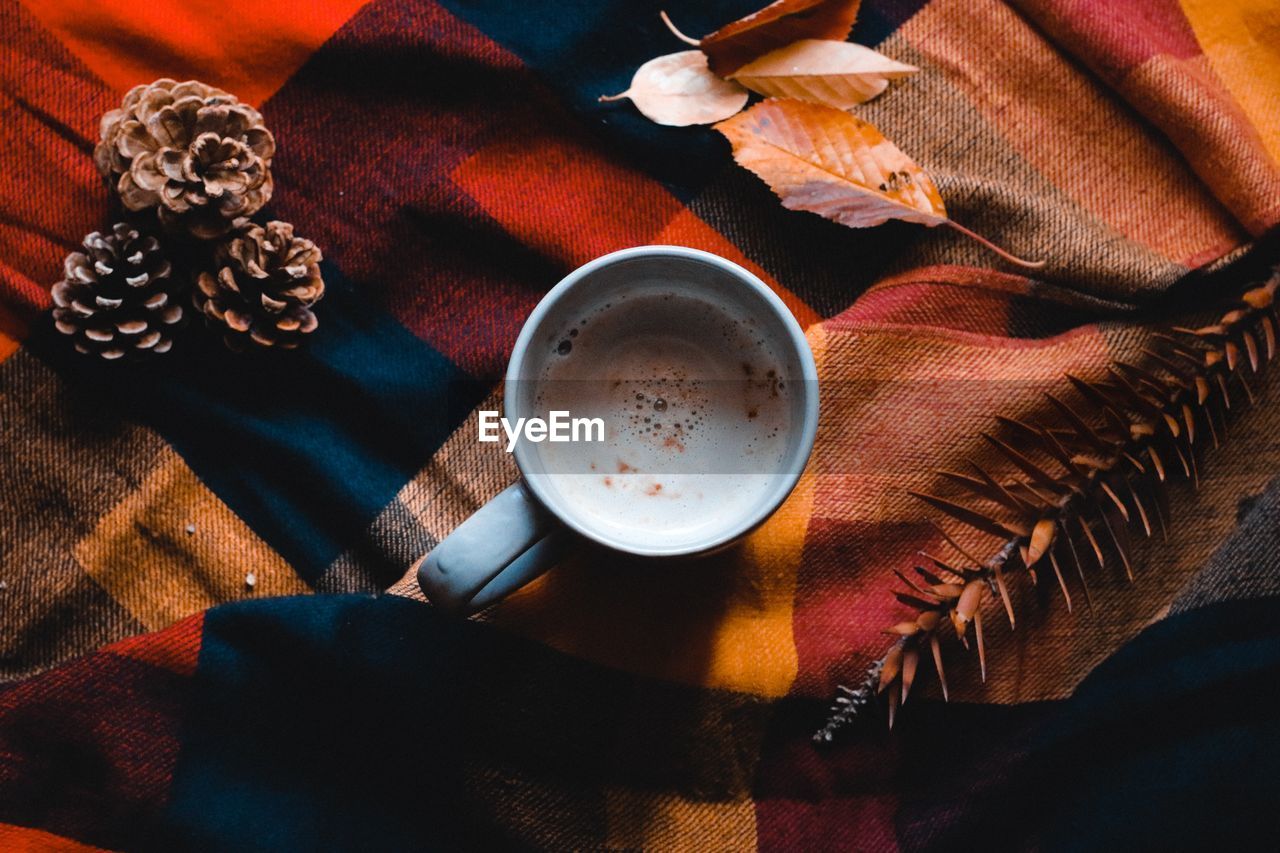 food and drink, drink, table, refreshment, cup, high angle view, mug, coffee, indoors, still life, food, no people, hot drink, red, coffee cup, freshness, wood, directly above, tea, textile, crockery