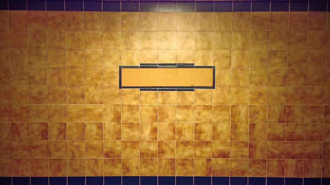 Full frame shot of tiled wall at subway station