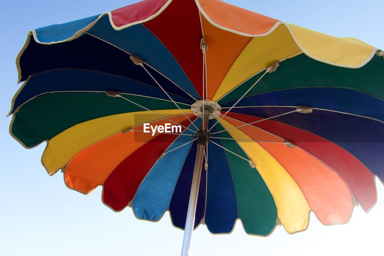 umbrella, fashion accessory, protection, multi colored, security, sky, nature, blue, parasol, windsports, parachute, environment, yellow, vibrant color, outdoors, no people, orange, clear sky