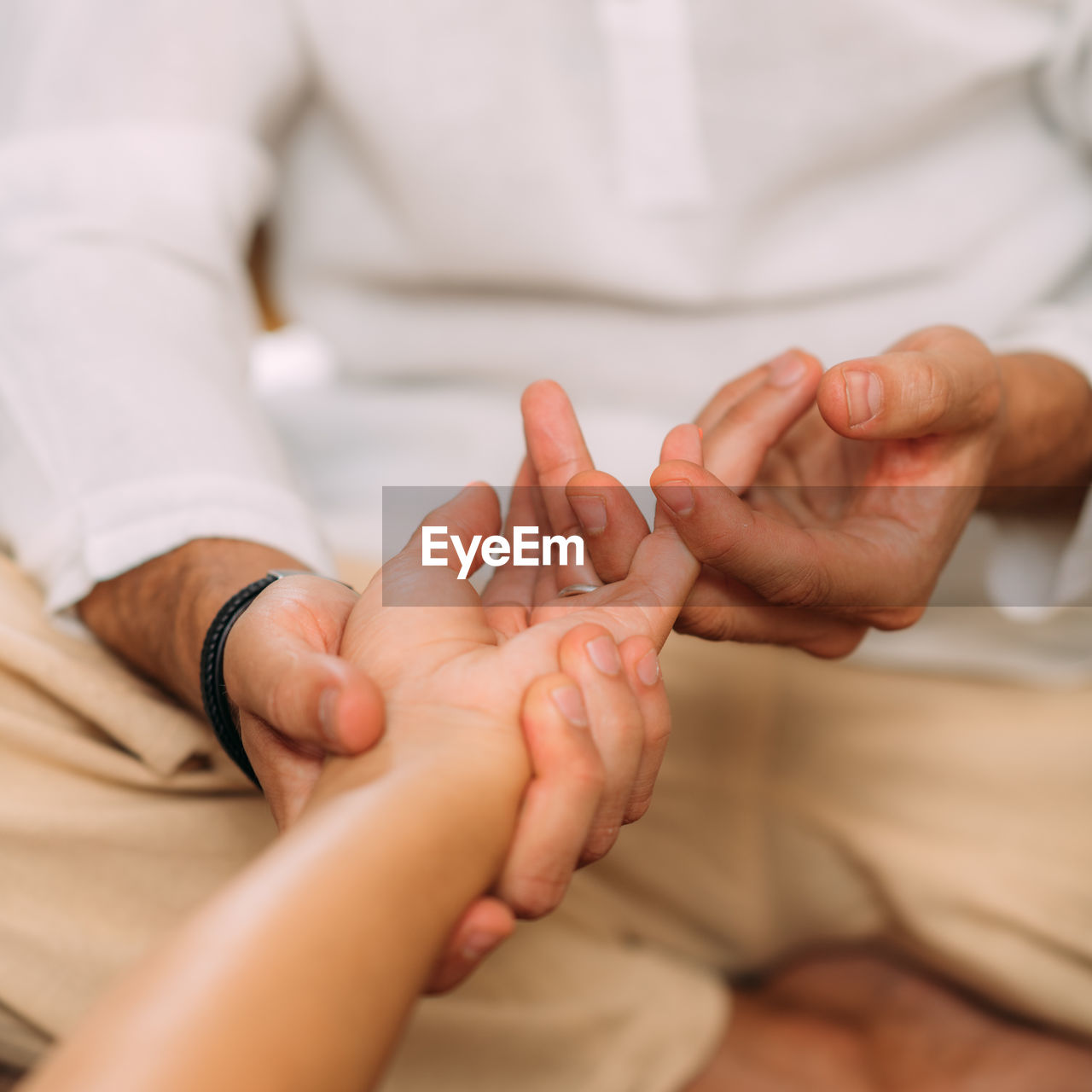 Shiatsu hand massage. therapist massaging the heart meridian.