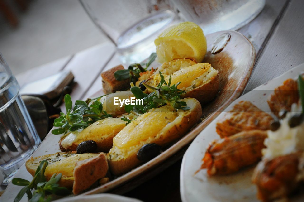 Close-up of greek food served in plates on table