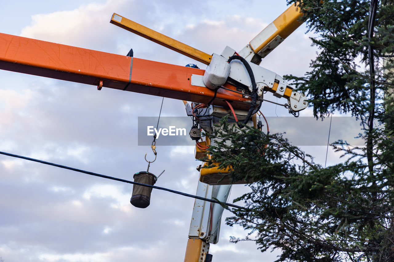 sky, cloud, nature, vehicle, low angle view, mast, tree, outdoors, transportation, no people, technology, industry, architecture, day, plant