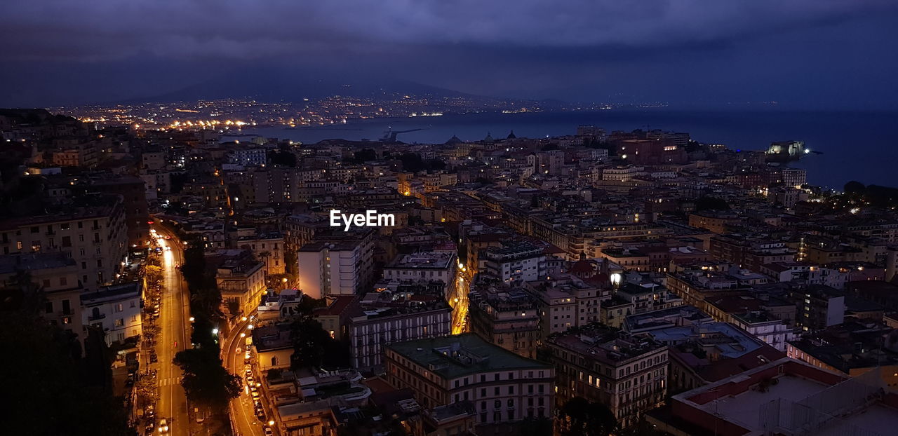 High angle view of illuminated city buildings at night