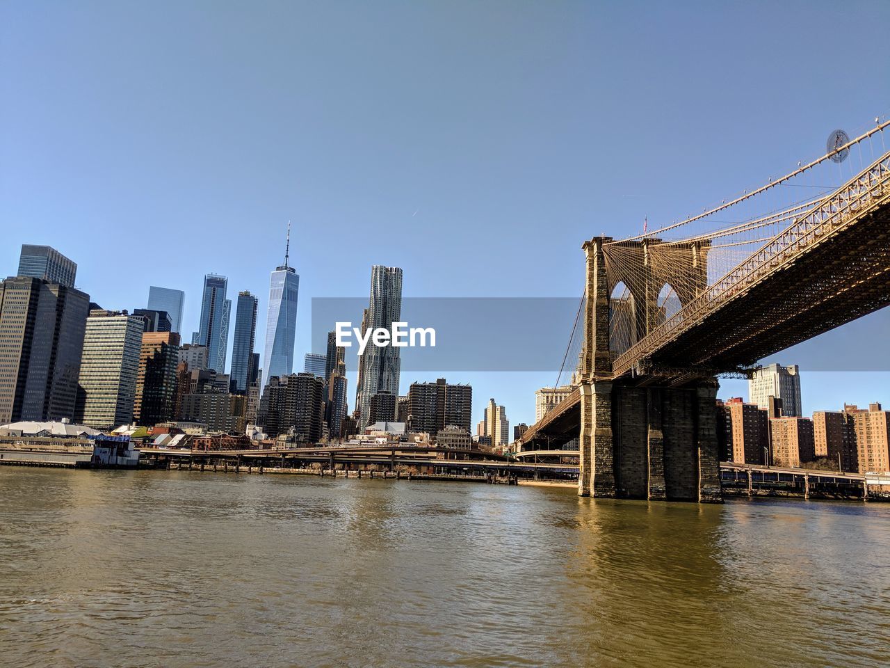 Bridge over river with city in background