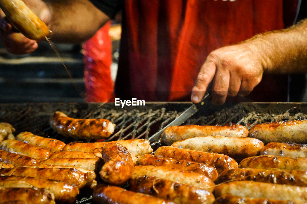 Man preparing sausage on grill