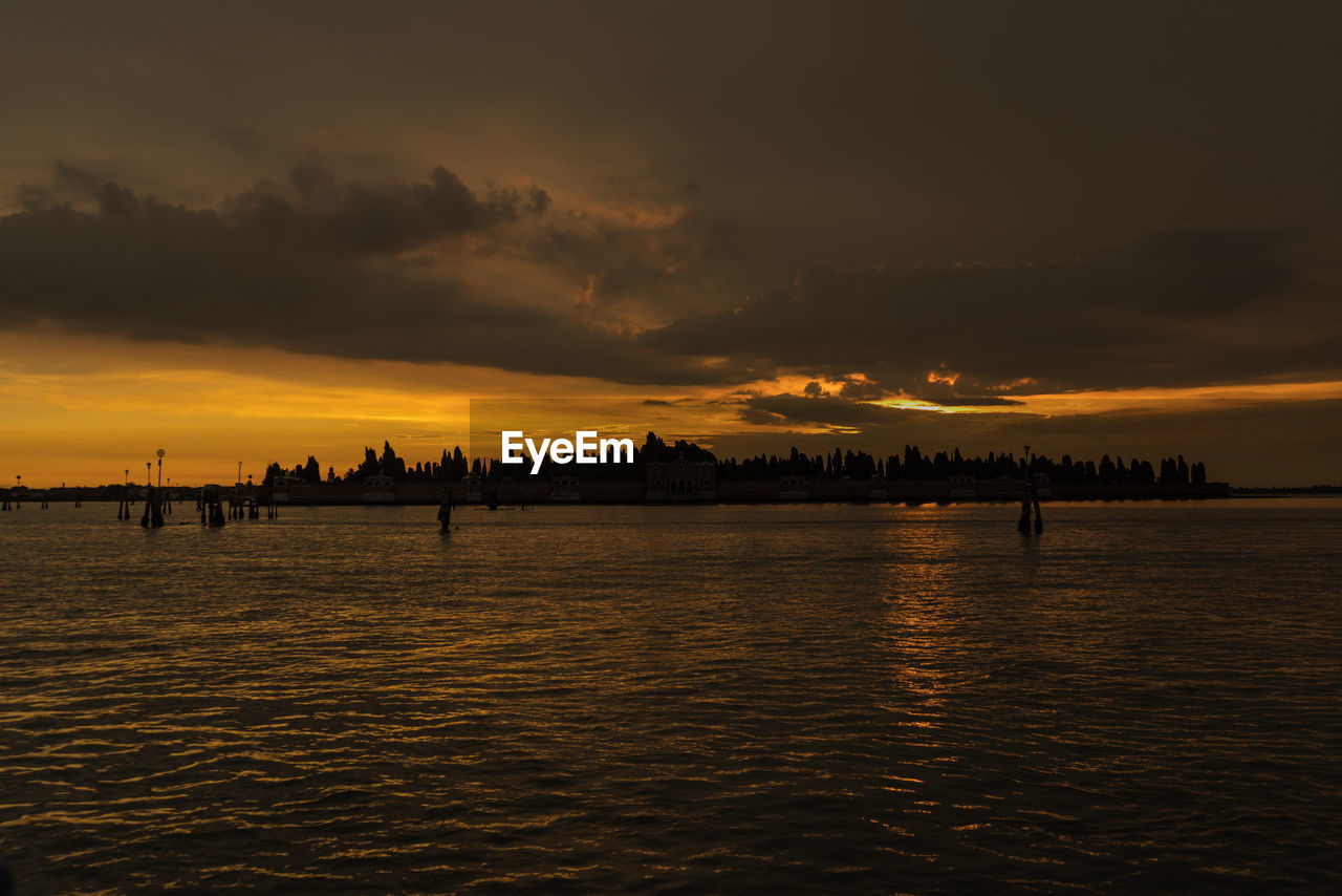 Scenic view of sea against orange sky