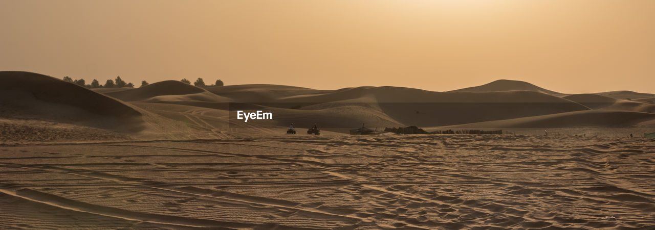 Scenic view of desert against sky during sunset