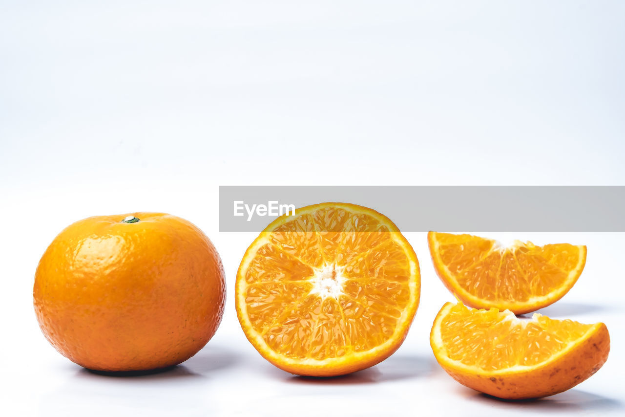 Close-up of oranges against white background