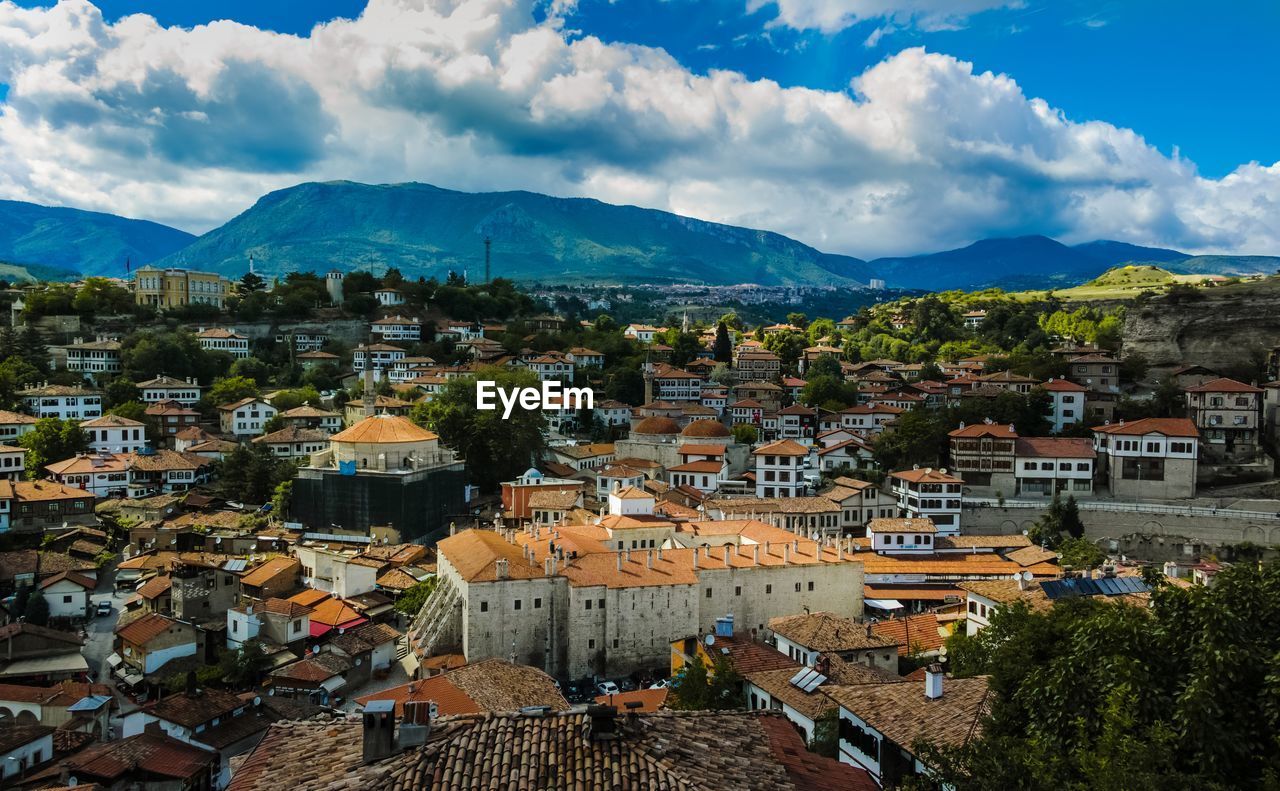 High angle view of town against cloudy sky