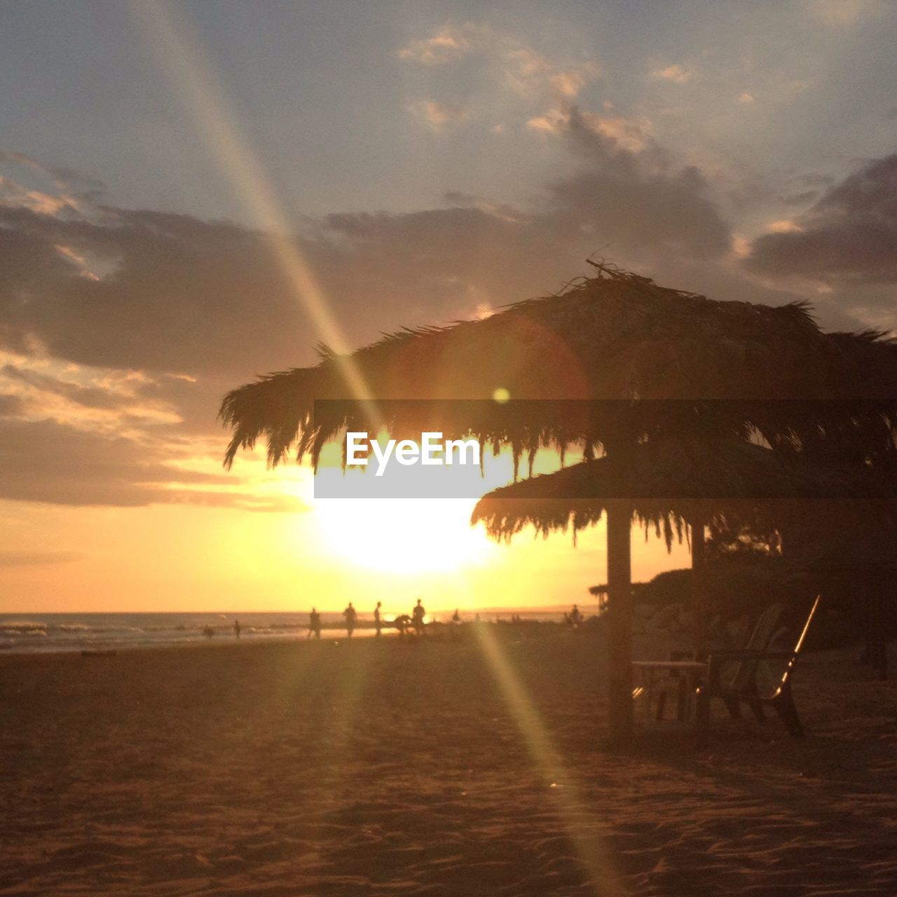 SILHOUETTE OF PEOPLE ON BEACH AT SUNSET