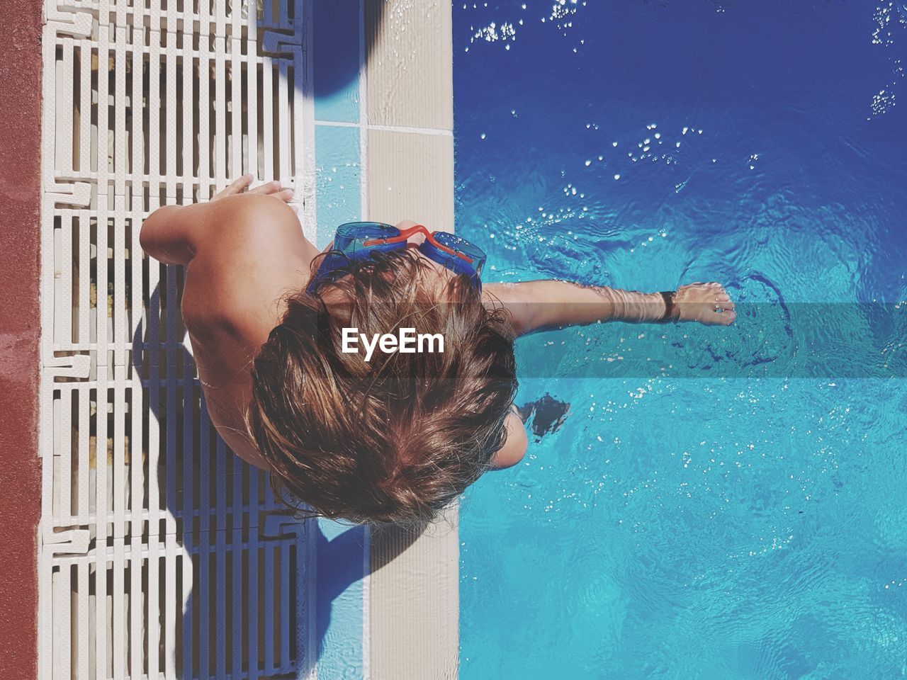 Directly above shot of boy at swimming pool