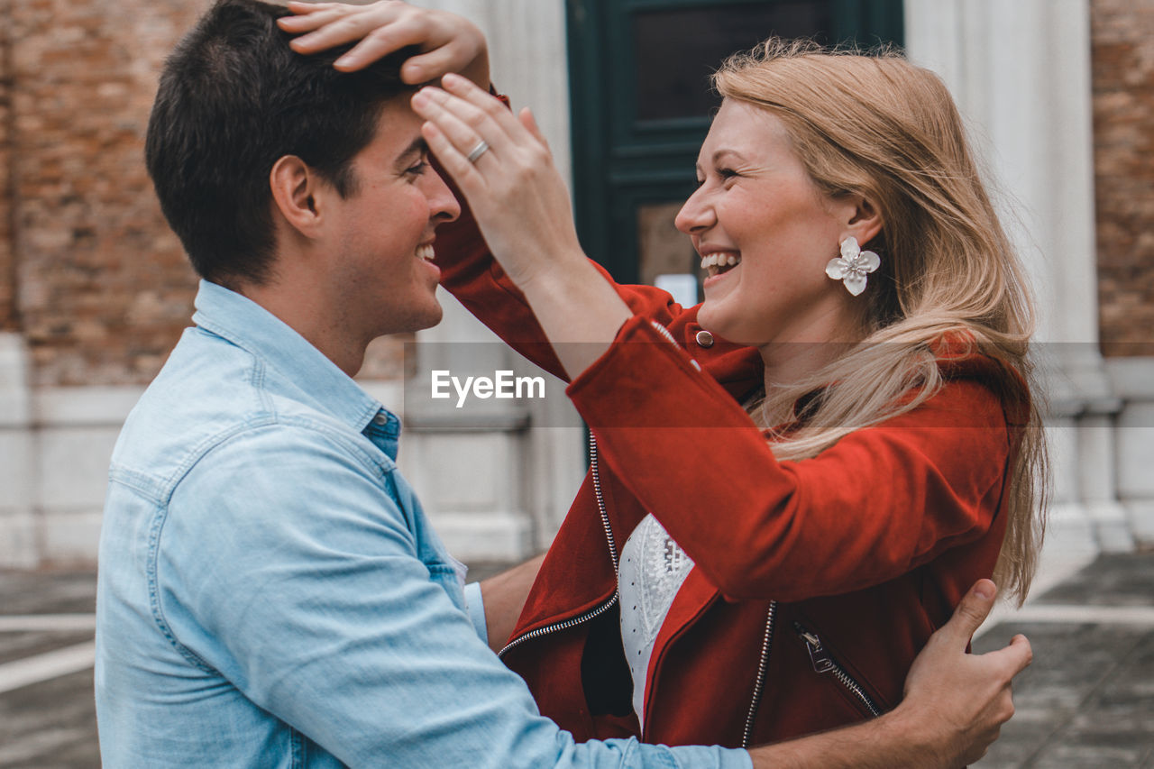 Smiling couple standing in city