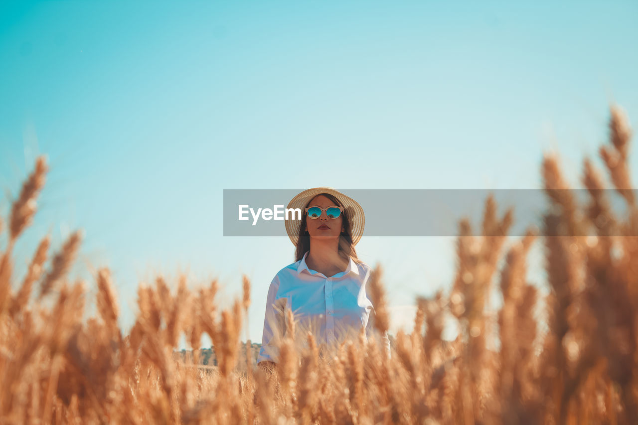 Woman standing on agricultural field