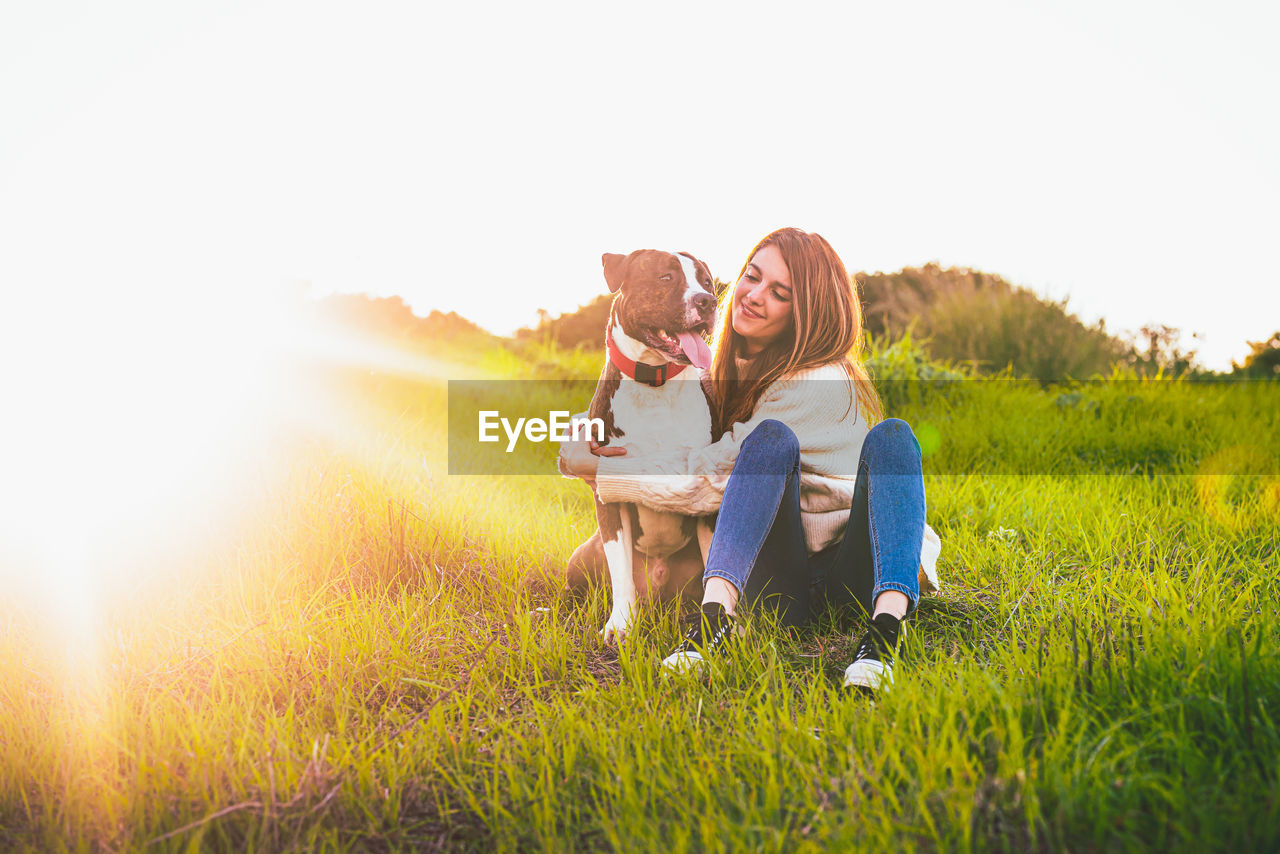 Woman with dog on field