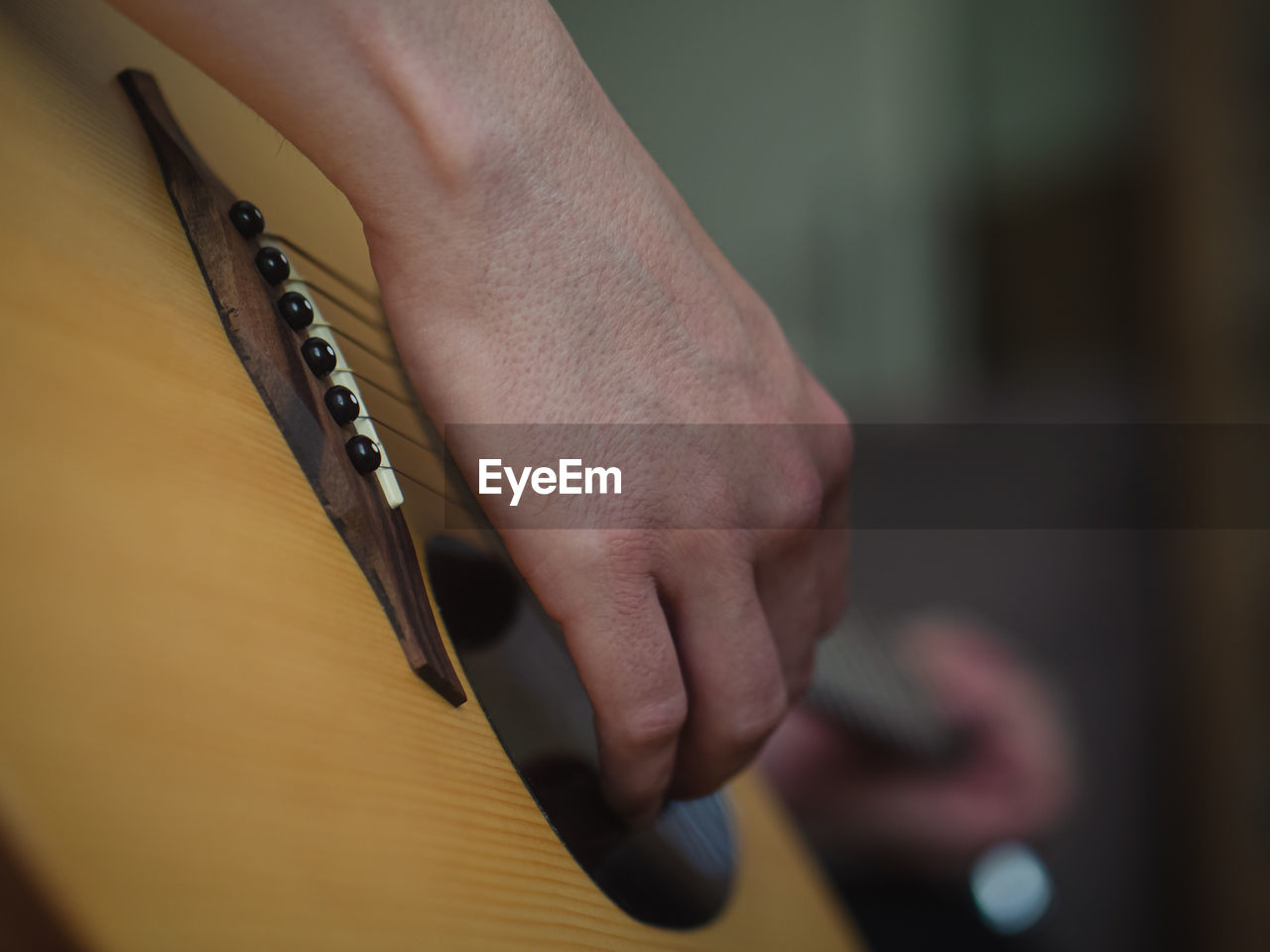 Cropped hand of woman playing guitar