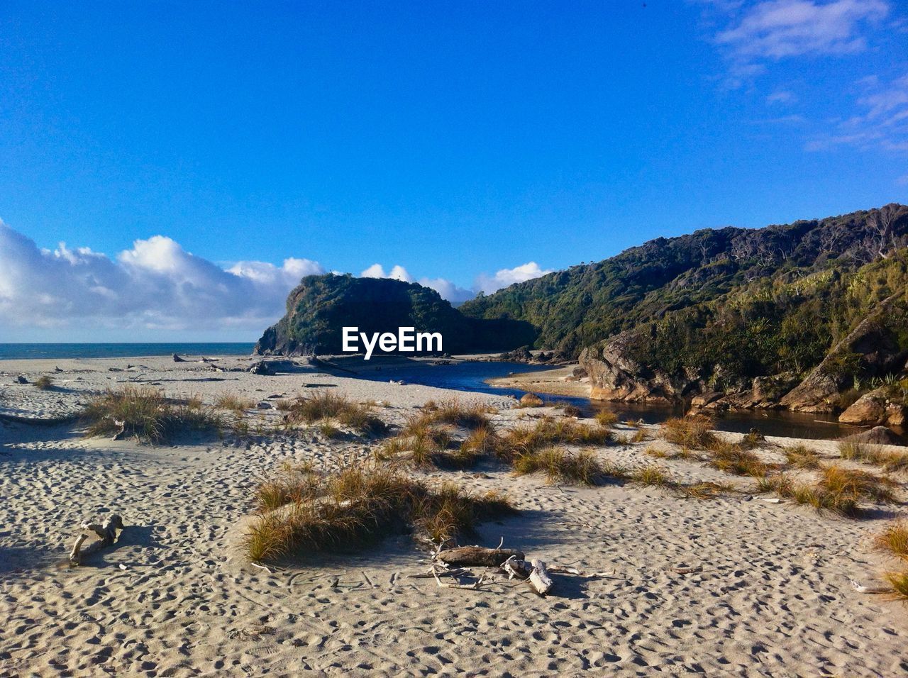 Scenic view of beach against blue sky