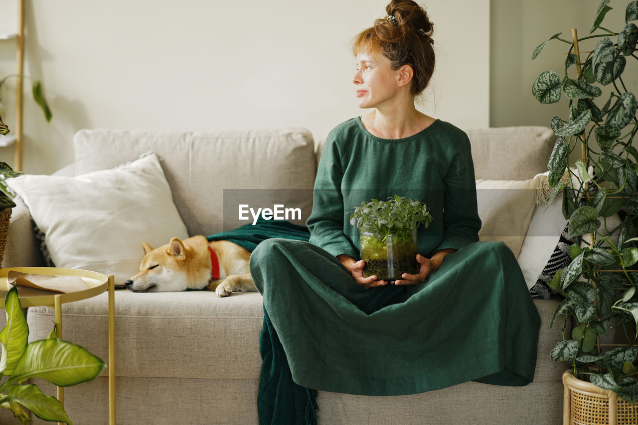 Home gardening and phyto design. funny woman holding diy florarium