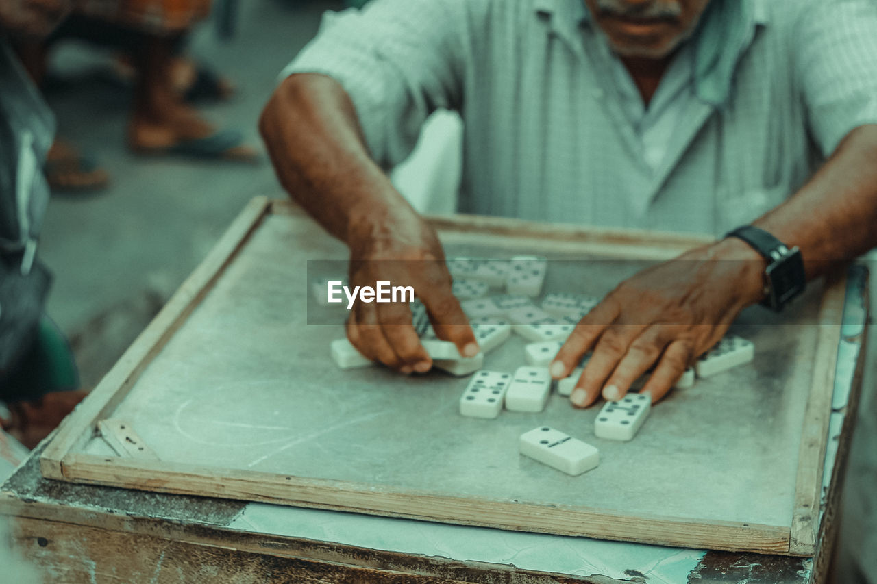 A man plays a game of domeno in mukalla, yemen