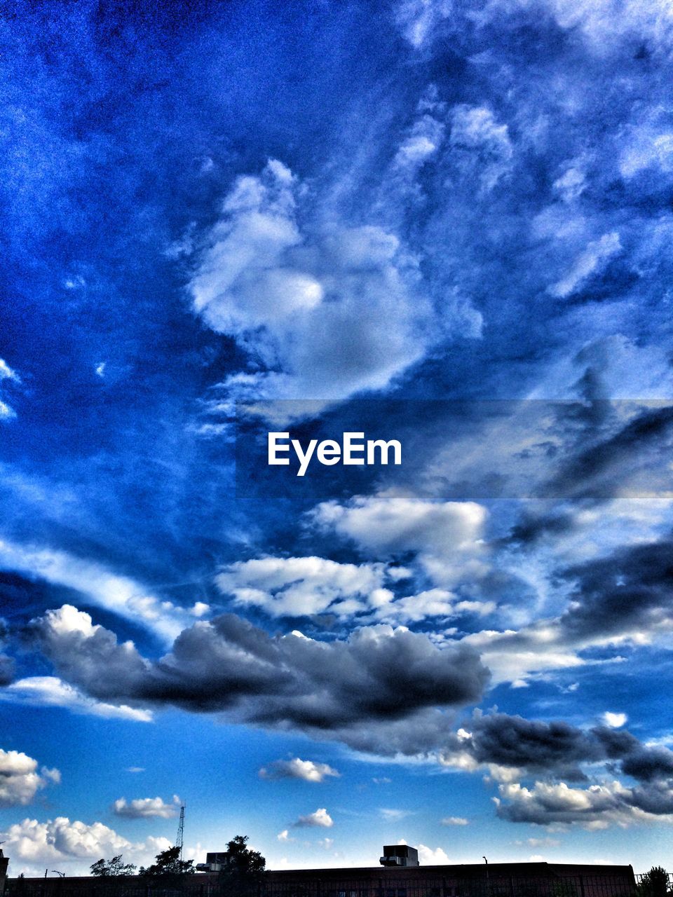 LOW ANGLE VIEW OF CLOUDY SKY OVER BLUE BACKGROUND