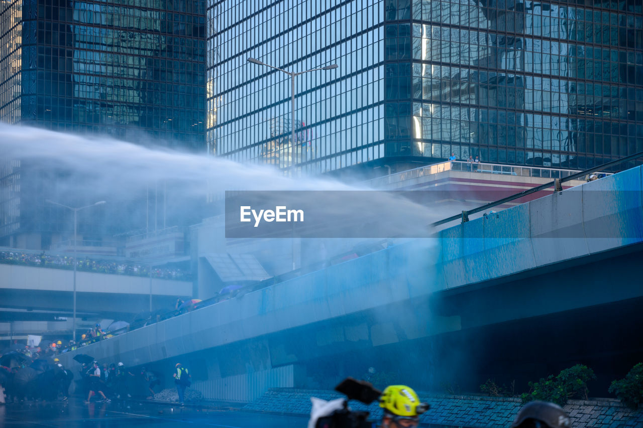 PEOPLE IN MODERN GLASS BUILDING