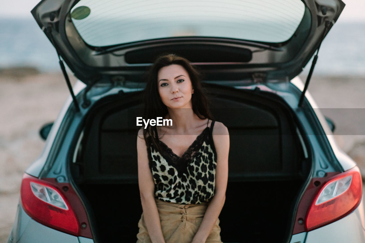 Portrait of a beautiful young woman in car