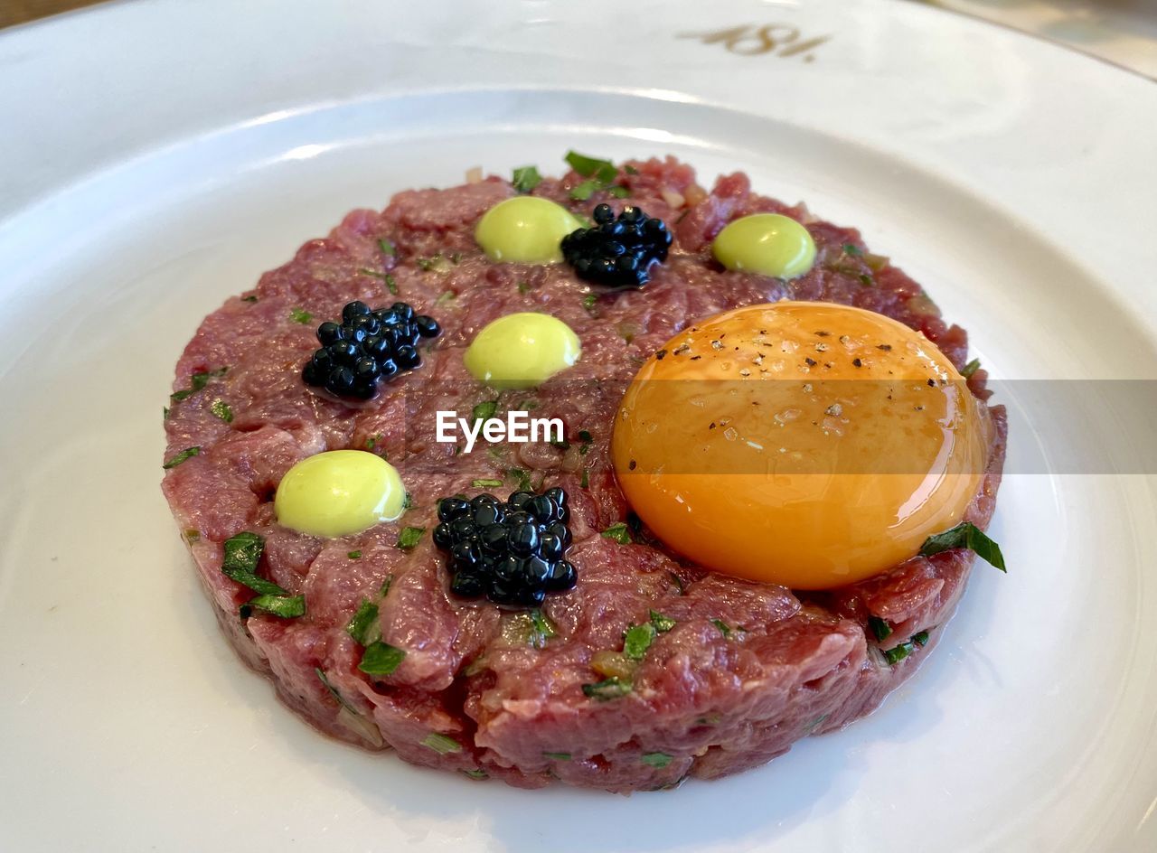 food and drink, food, steak tartare, meat, healthy eating, plate, dish, meal, freshness, vegetable, breakfast, no people, produce, fruit, indoors, egg, close-up, red meat, table, cuisine, beef, still life, fried
