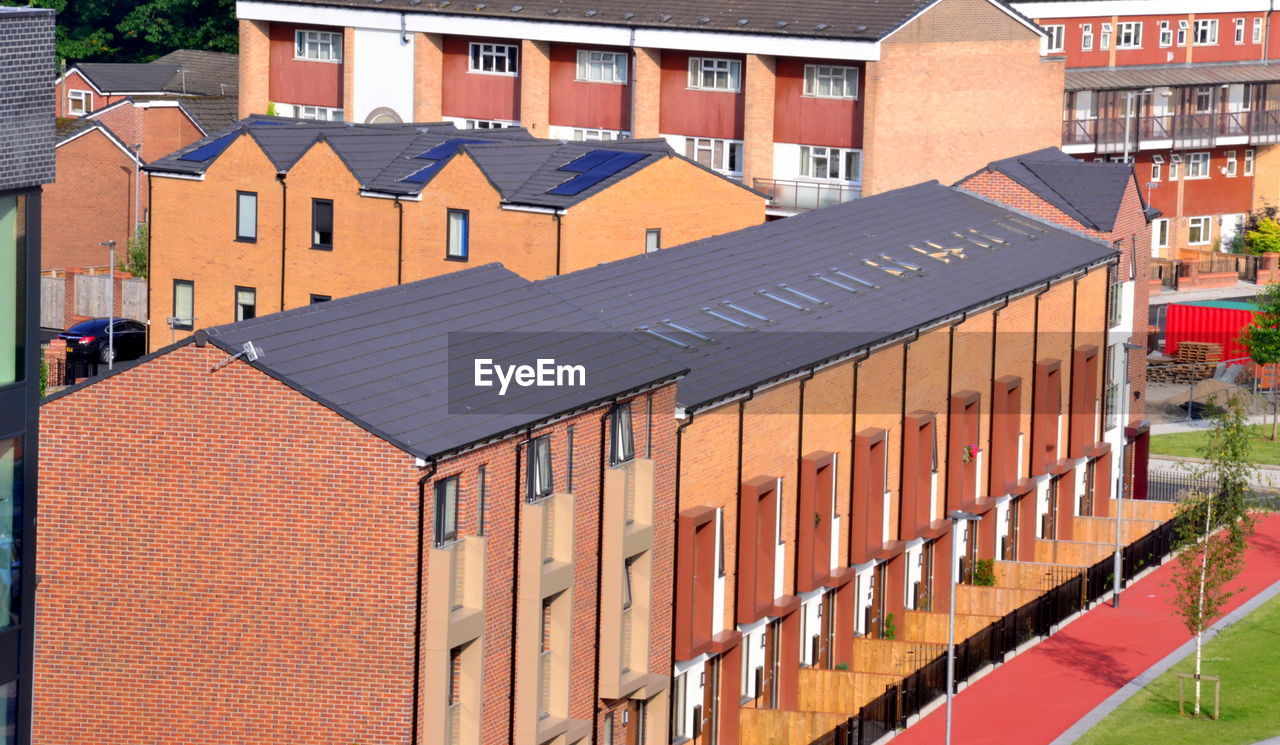 Overhead, view of new houses with older flats in the background in ardwick, manchester, uk