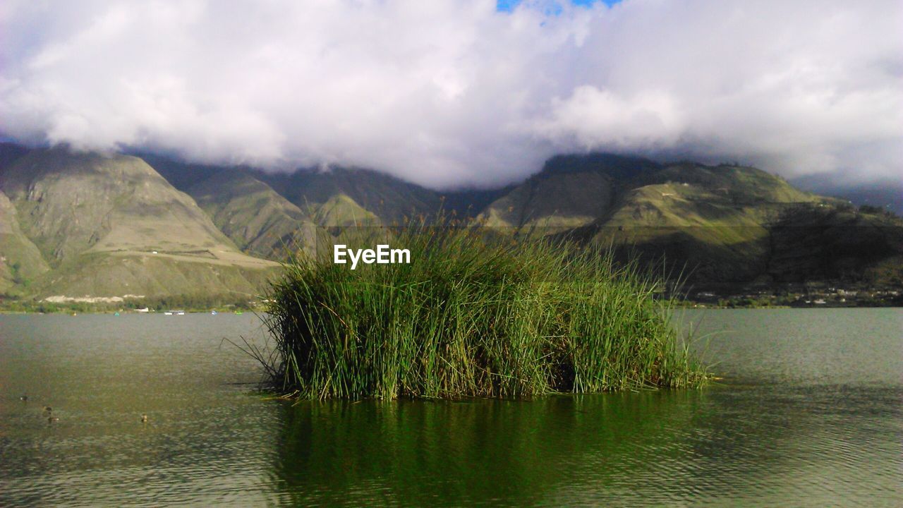 Scenic view of lake and mountains against sky