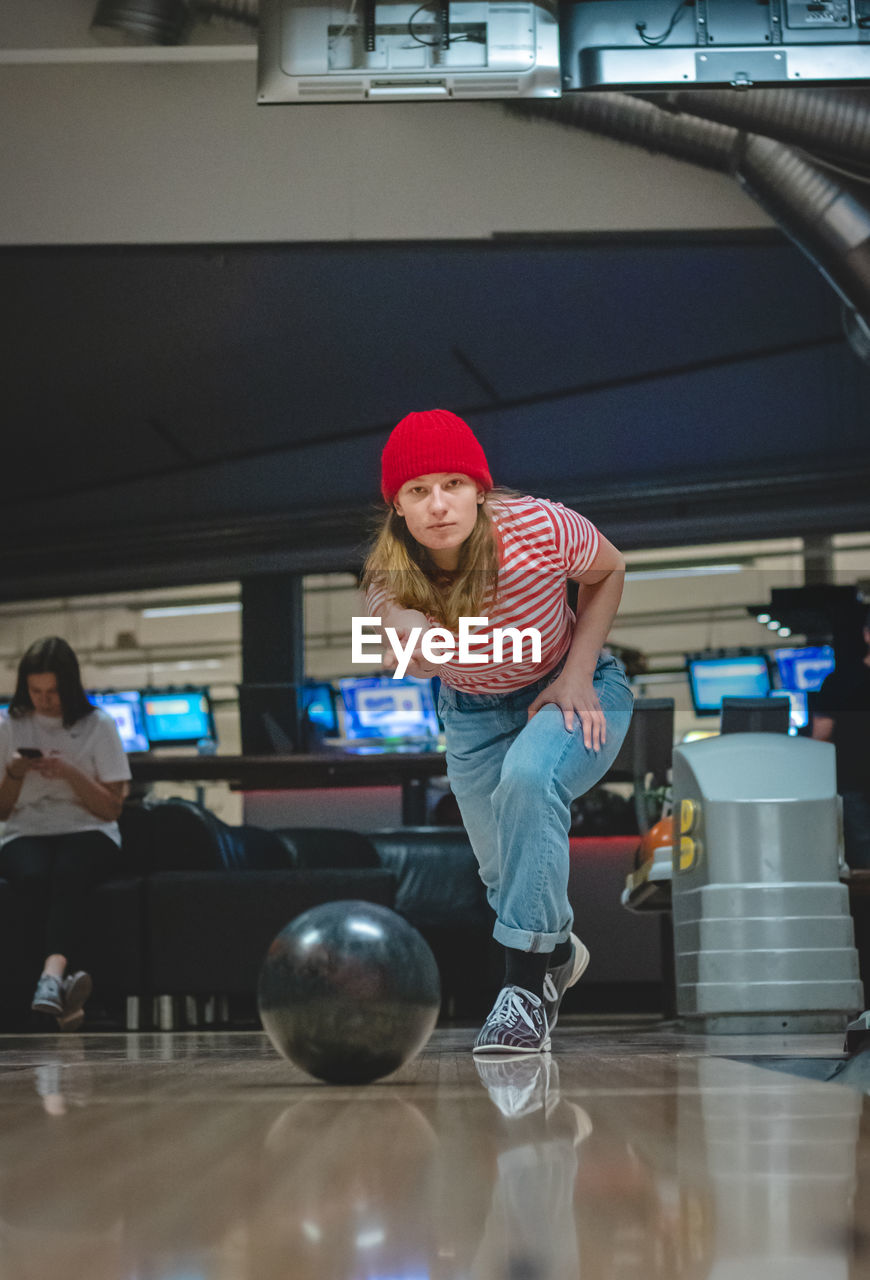 Professional female bowler throws his throw and is in position to watch his ball. bowling life. 