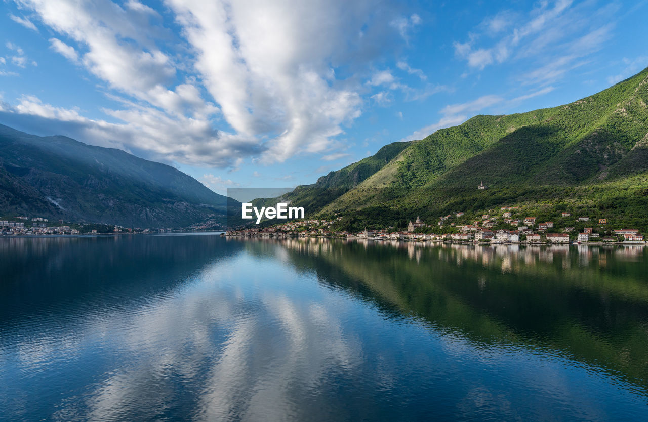 PANORAMIC VIEW OF LAKE BY MOUNTAINS AGAINST SKY