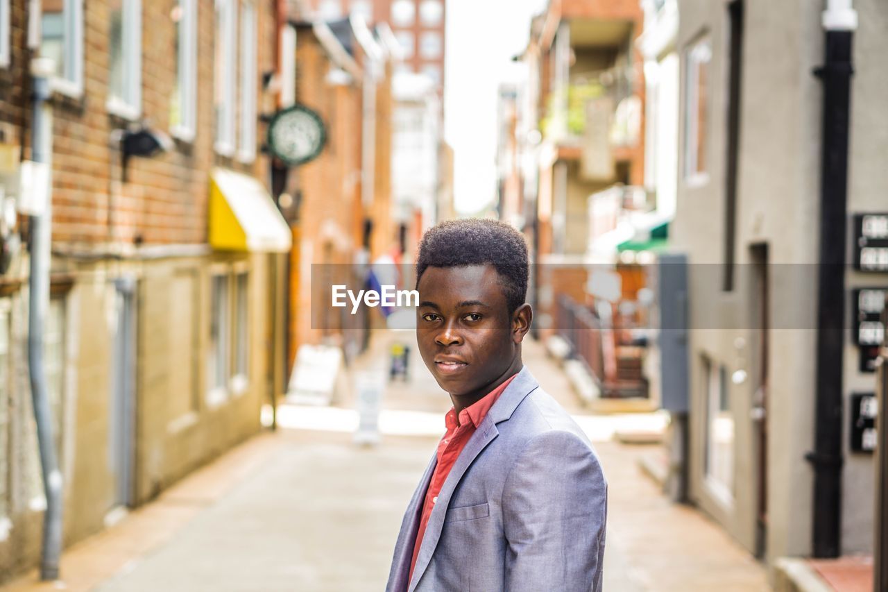 Portrait of happy man on urban street