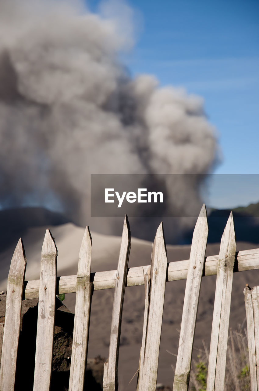 WOODEN POSTS AGAINST SKY