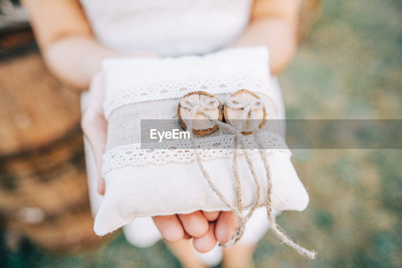 Midsection of woman holding gift outdoors