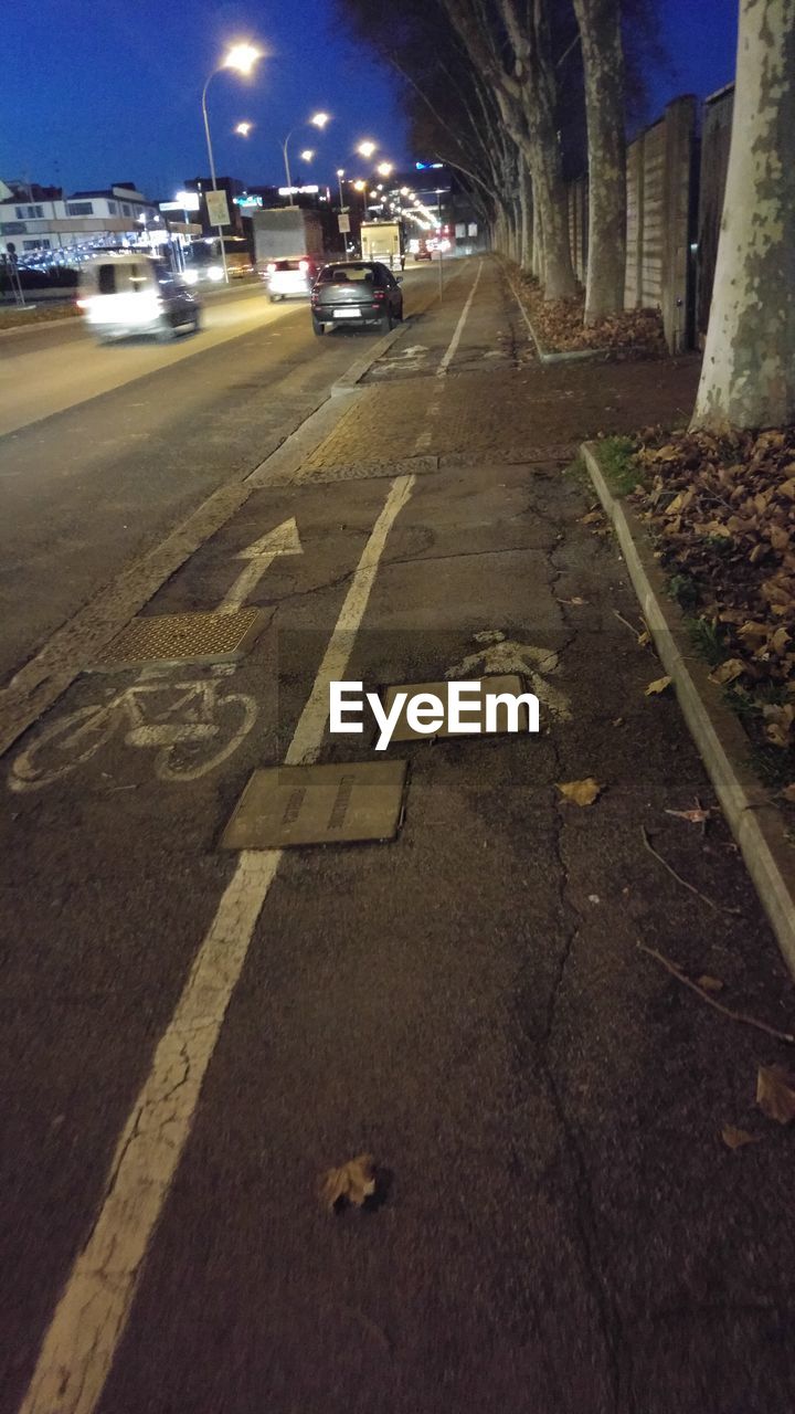 CARS IN ILLUMINATED STREET