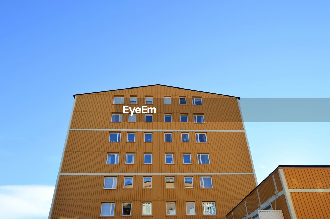 Low angle view of modern building against clear blue sky