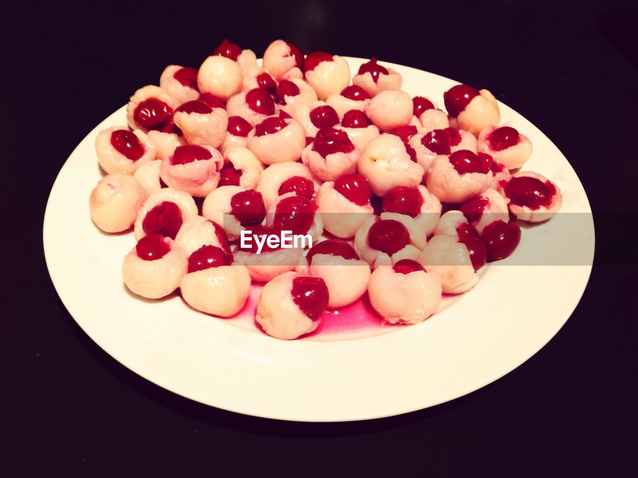 Pastry with cherries on plate