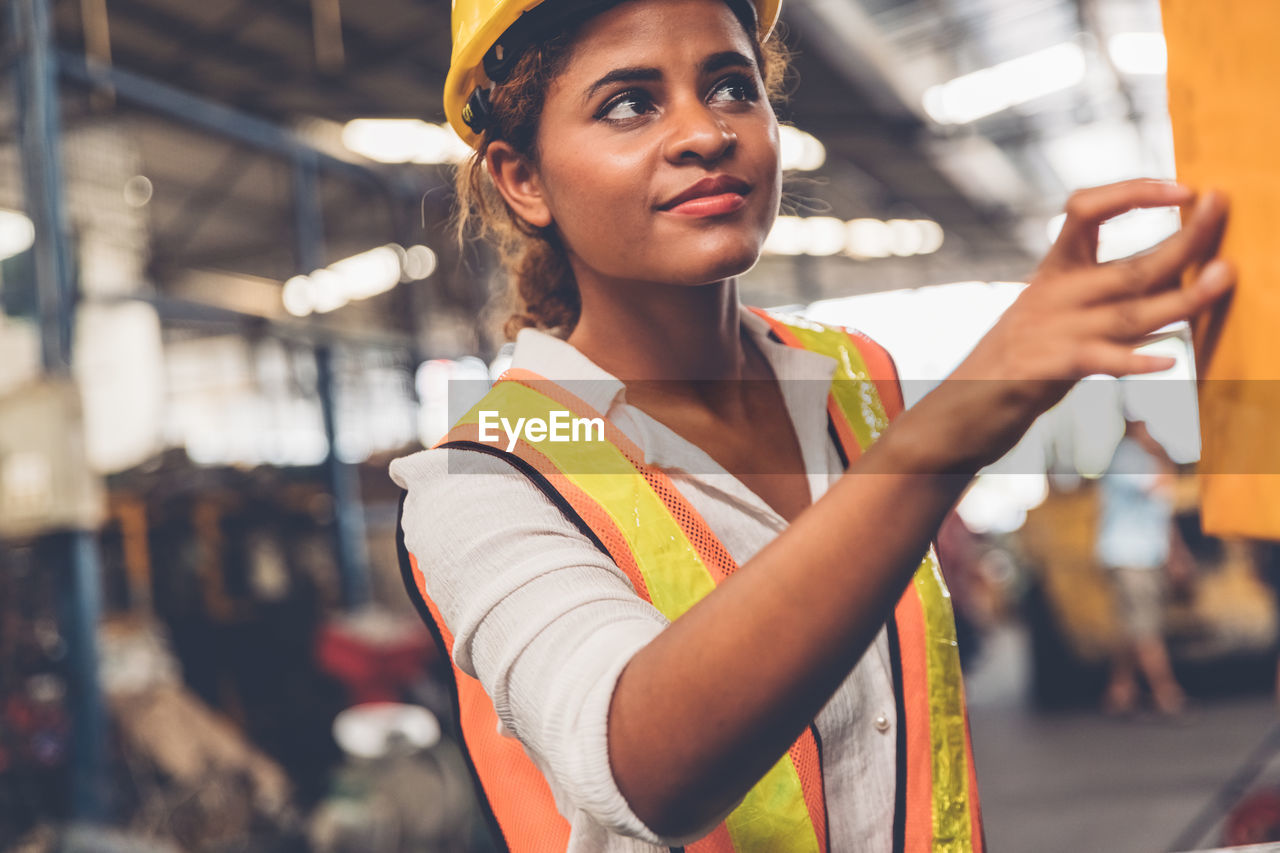 Young woman working in factory