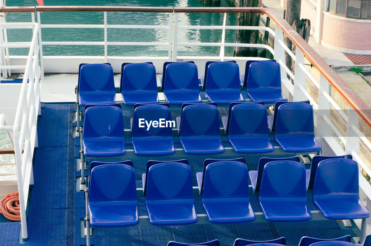 Empty blue chairs in a ferry boat