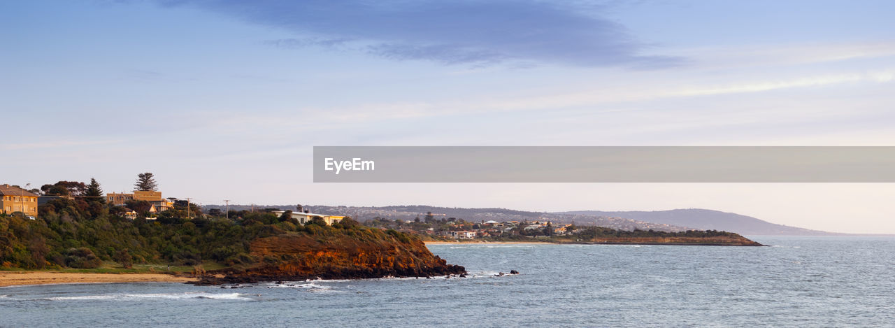 Scenic view of sea and buildings against sky