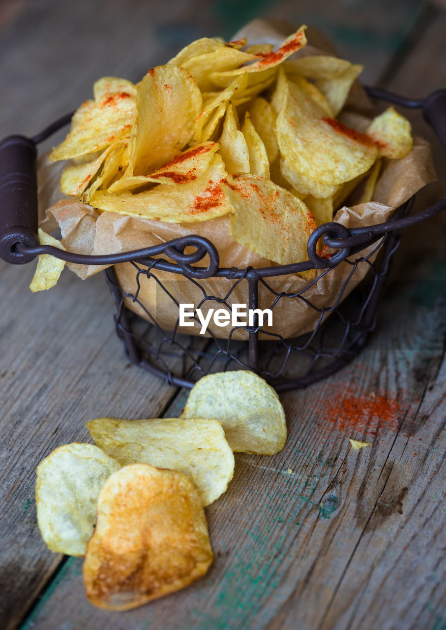 High angle view of fresh crunchy potato chips on table