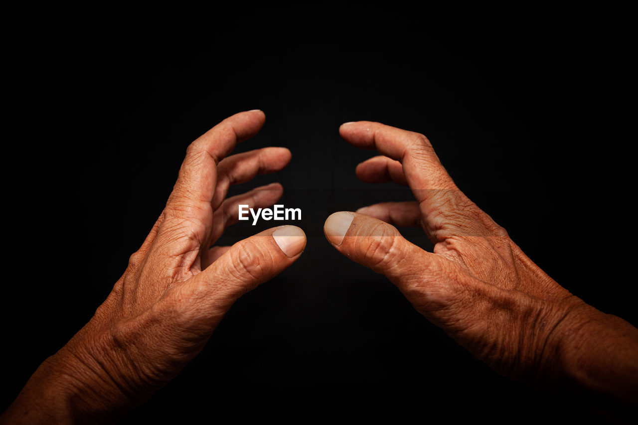 hand, close-up, black background, finger, adult, studio shot, men, arm, indoors, positive emotion, emotion, one person, limb