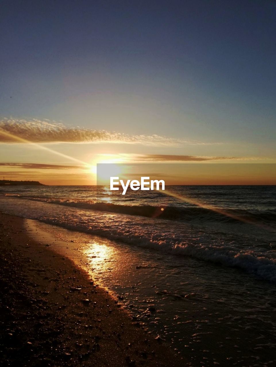 SCENIC VIEW OF BEACH DURING SUNSET