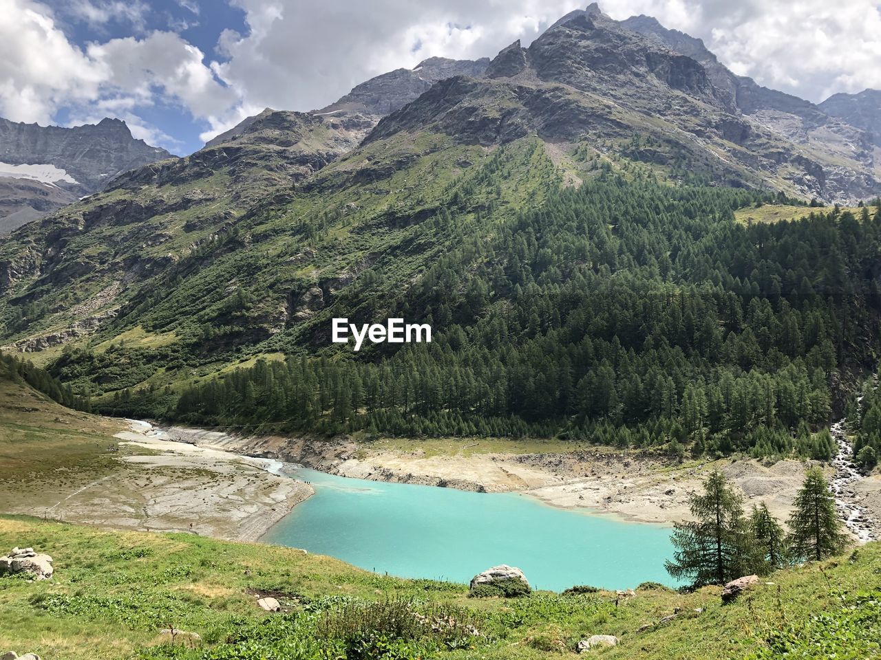 Scenic view of lake and mountains against sky
